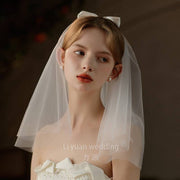Ivory Bow Bridal Veil made of soft chiffon tulle with elegant knot accent for weddings