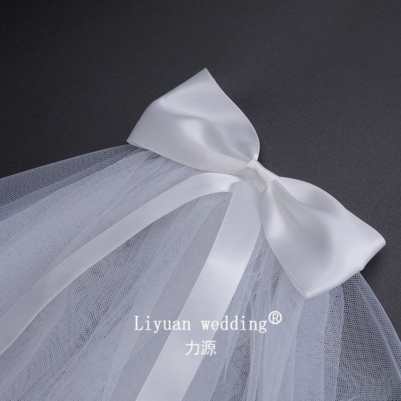 Ivory Bow Bridal Veil made of soft chiffon tulle with elegant knot accent, lightweight and sheer wedding headpiece
