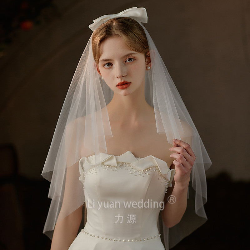 Double-layer mid-length bridal veil with satin ribbon bow and soft chiffon tulle