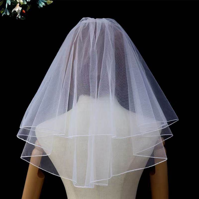 Ivory bow bridal veil made of soft chiffon tulle with elegant knot accent for weddings
