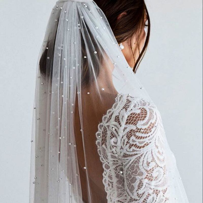 Beaded mid-length bridal veil in soft lace tulle, lightweight and elegant for weddings and travel