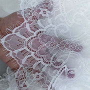 Black and white eyelash lace cathedral bridal veil with long wedding train headpiece on soft chiffon tulle background