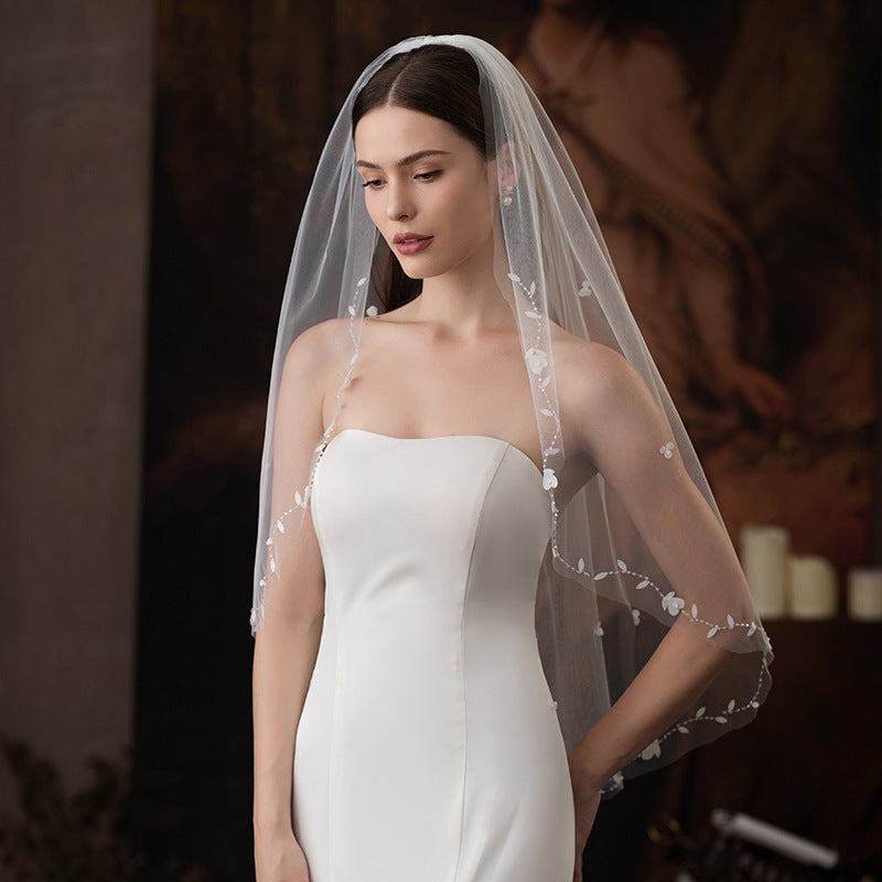 Heart flower hair comb on sheer single-layer bridal veil with lace detailing