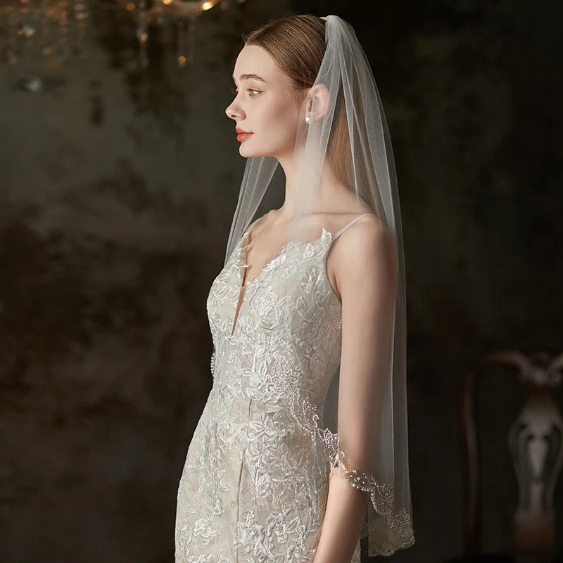 Embroidered soft tulle bridal veil in pure white, lightweight and sheer, designed for elegant wedding styles