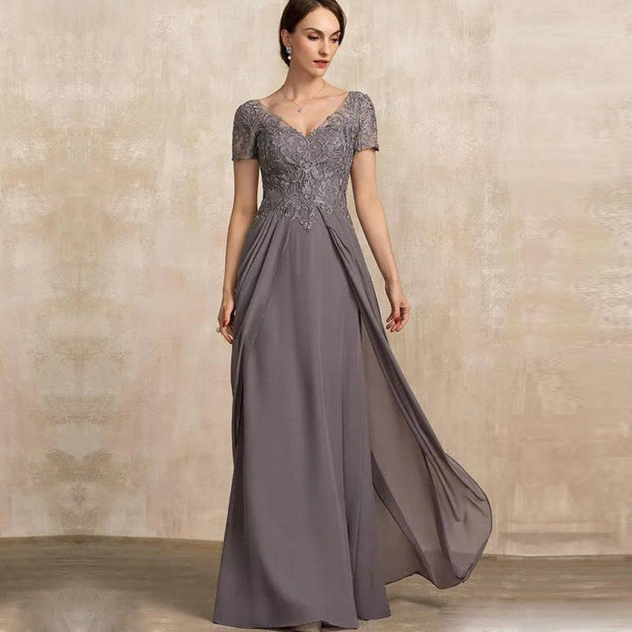 Chiffon long evening gown in dusty gray with lace appliqué bodice, short sleeves, V-neckline, and flowing skirt design.