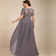 Chiffon long evening gown in gray with lace short sleeves and sheer embroidered back, flowing skirt and elegant design.