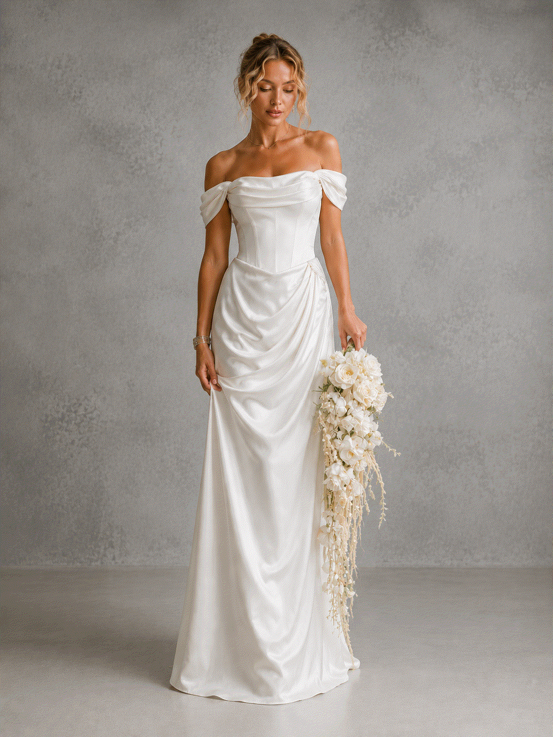 cowl neck satin wedding dress in ivory with off-shoulder sleeves, a structured corset bodice, and draped waist