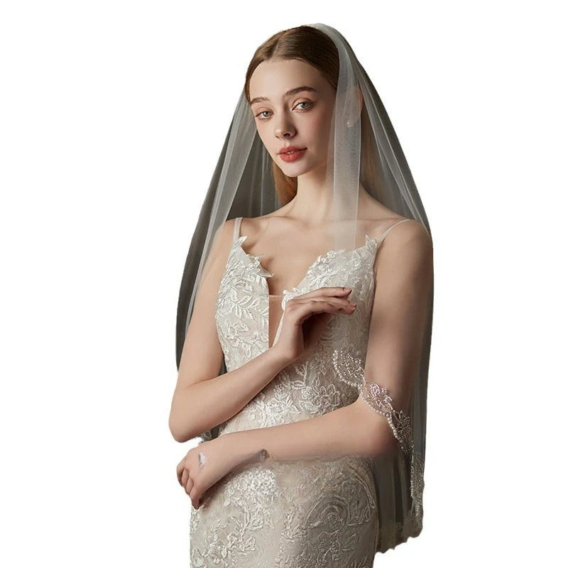 Embroidered soft tulle bridal veil in pure white, lightweight and sheer, perfect for fairy forest wedding style.