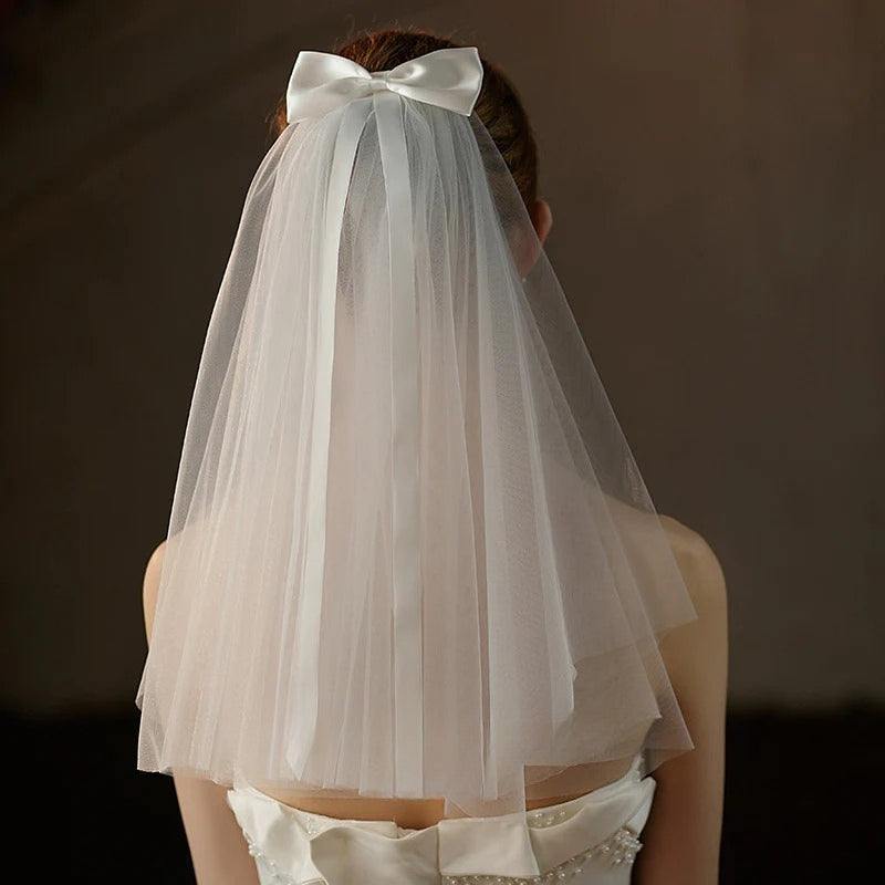 Ivory bow bridal veil made of soft plain tulle with elegant knot accent