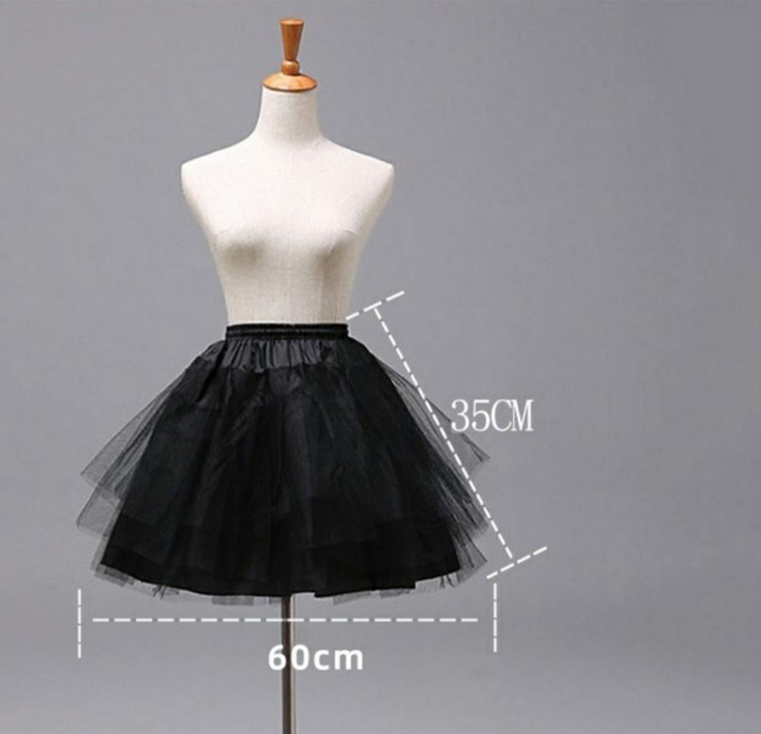 Girls White Petticoat underskirt, shown in black sheer layered tulle with an elastic waistband and flared shape.
