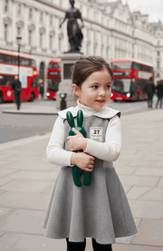 Girls Woolen Sleeveless Sporty Dress in grey with a textured flared skirt, white ribbed top and collar, and numbered badge.