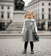 Girls Woolen Sleeveless Sporty Dress in grey, with a smooth sleeveless bodice, white collar and flared skirt.