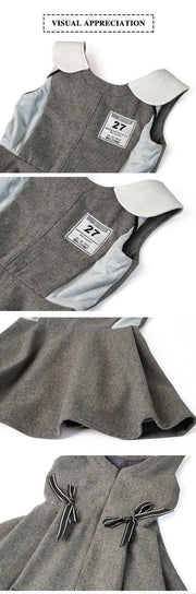 Girls Woolen Sleeveless Sporty Dress in grey textured fabric with white collar and side panels, featuring a chest badge and bow details.