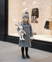 Girls' Woolen Winter coat in solid grey wool, with a long double-breasted cut, rounded collar and dark buttons.