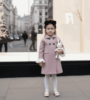 Girls' Woolen Winter coat in dusty pink wool, with a long double-breasted design, dark buttons, and white ruffled cuffs.