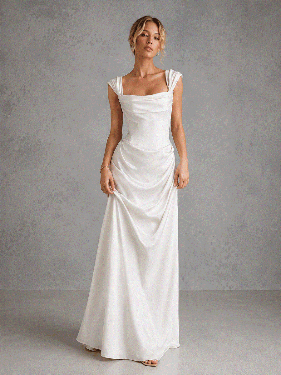 Ivory satin off-shoulder corset wedding guest dress with draped waist and flowing skirt