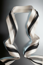 Ivory and charcoal satin ribbons set with layered widths for elegant styling and gift wrapping