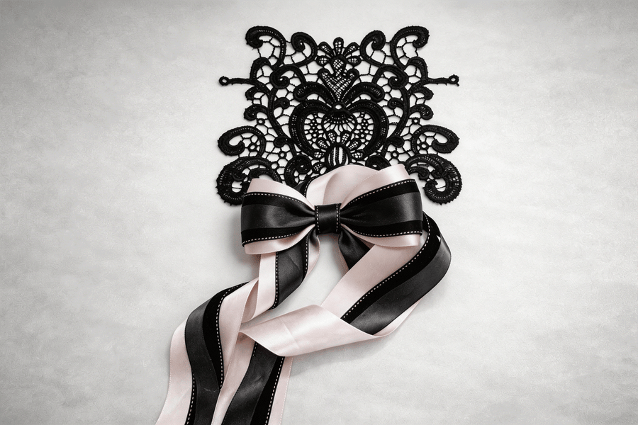 Blush structured lace set with black floral applique and layered satin ribbons for elegant styling