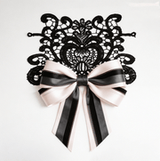 Blush structured lace set with black textured and grey layered ribbons featuring floral lace applique for elegant wedding decor and styling