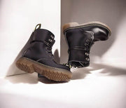 Kids Black Matte Leather Boots in black with lace-up fronts, metal eyelets, ankle straps and tan lugged rubber soles.