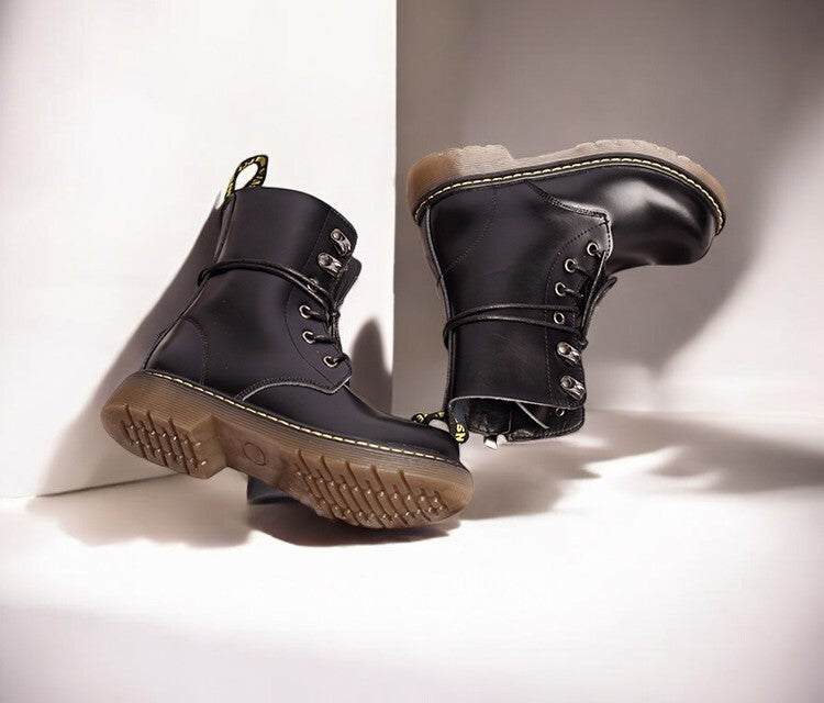 Kids Black Matte Leather Boots in black with lace-up fronts, metal eyelets, ankle straps and tan lugged rubber soles.