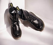 Kids Black Matte Leather Boots in black leather with lace-up fronts, padded collars, yellow contrast stitching and chunky soles.