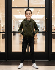 Kids' Velvet Blazer, despite the label, is an olive-green hooded zip jacket with black trousers and white trainers.