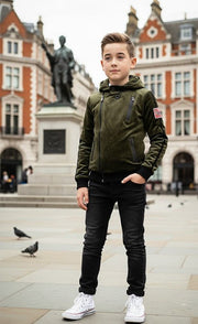 Kids' Velvet Blazer in olive green plush fabric, featuring a hood, front zip and angled pockets, paired with black jeans