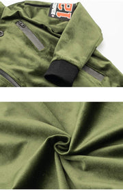 Kids' Velvet Blazer in olive green plush fabric, with black ribbed cuffs, gray zip pockets and a sporty number patch.