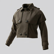 Girls' Cotton Trench Coat in dark olive cotton, cropped with long sleeves, a storm flap, collar and double-breasted buttons.